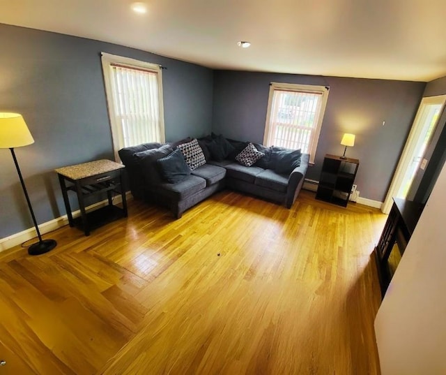 living room featuring light hardwood / wood-style flooring and a baseboard heating unit