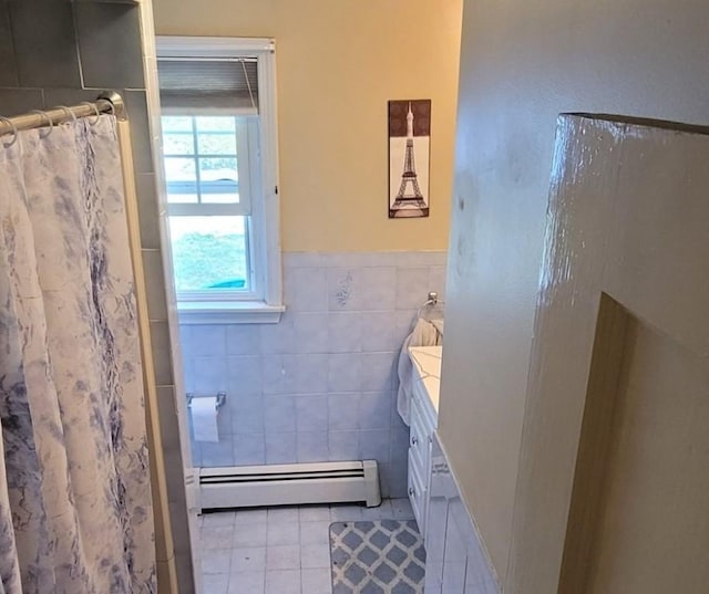 bathroom featuring tile walls, a baseboard heating unit, vanity, a shower with curtain, and tile patterned floors