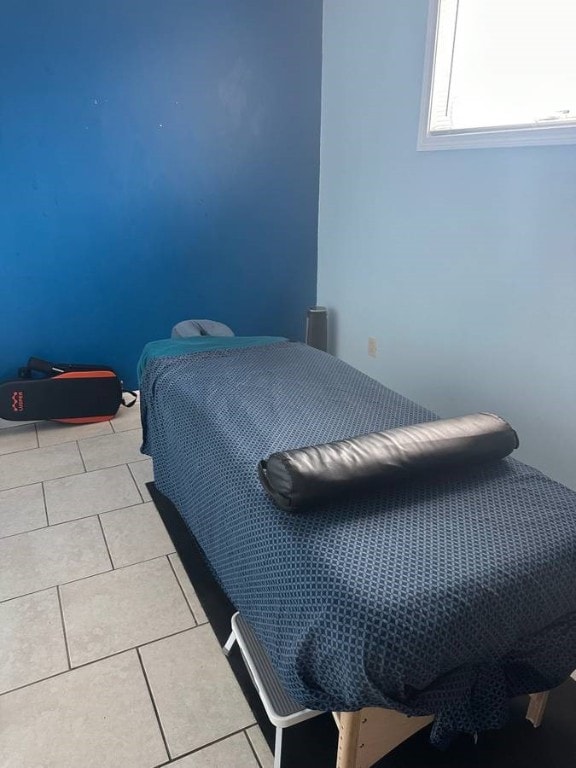 bedroom featuring light tile patterned floors