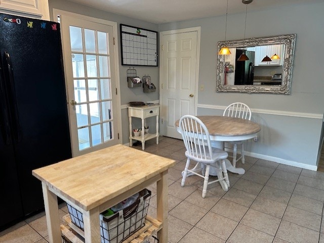 dining area with light tile patterned flooring and baseboards