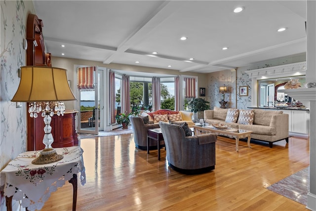 living room featuring light wood-type flooring, beam ceiling, and coffered ceiling