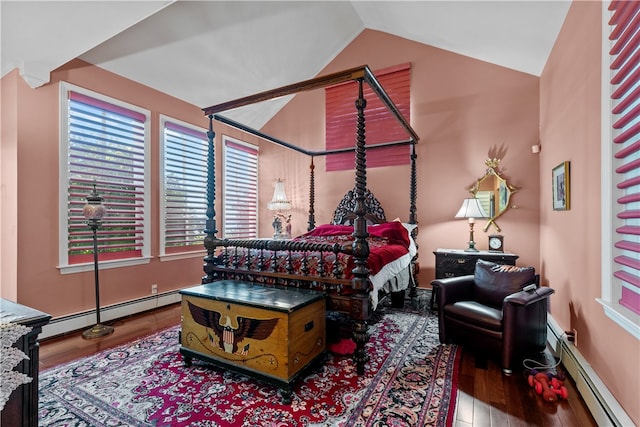 bedroom featuring lofted ceiling, hardwood / wood-style floors, and a baseboard heating unit