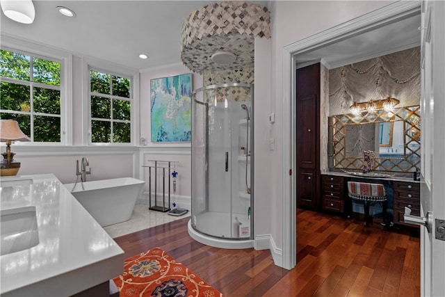 bathroom with independent shower and bath, vanity, hardwood / wood-style floors, and ornamental molding