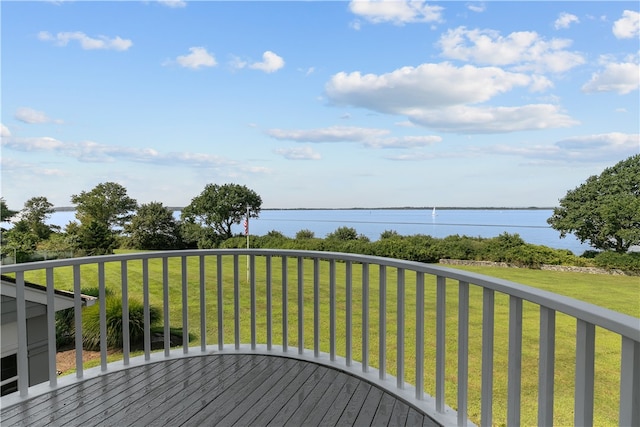 wooden deck with a water view and a yard