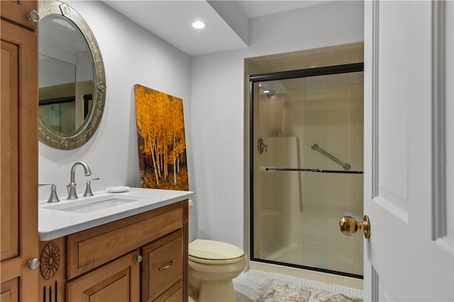 bathroom with vanity, toilet, tile patterned floors, and an enclosed shower