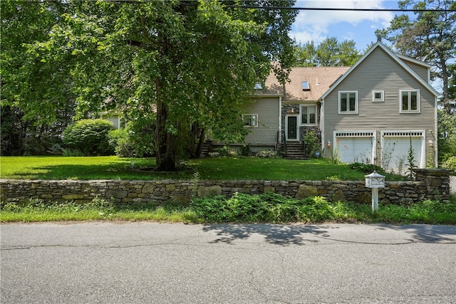 view of front of home featuring a front yard and a garage