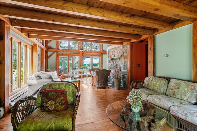 living room with beamed ceiling and plenty of natural light