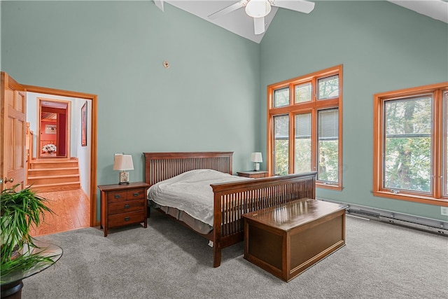 carpeted bedroom with ceiling fan and high vaulted ceiling