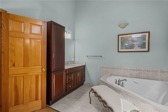 bathroom with vanity, a relaxing tiled tub, and tile patterned floors