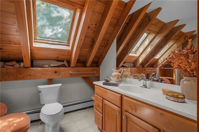 bathroom featuring toilet, a baseboard heating unit, vanity, and vaulted ceiling with skylight