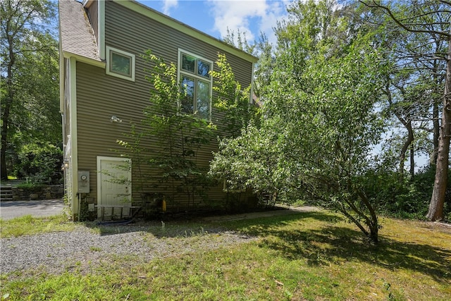 view of property exterior featuring a lawn