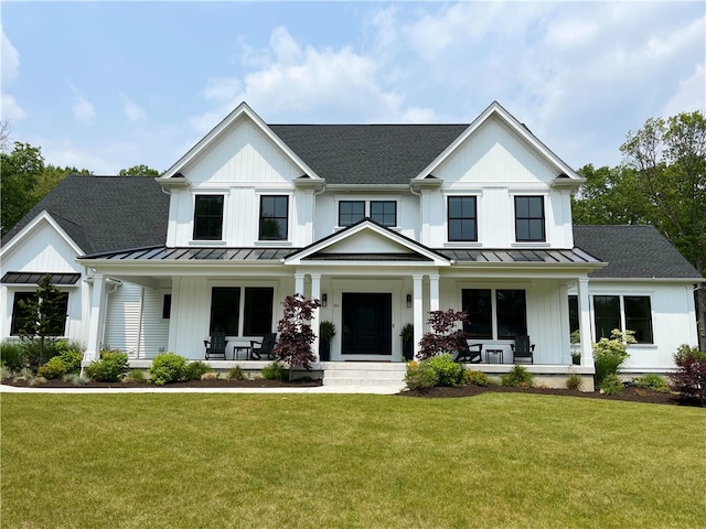 modern farmhouse featuring a porch and a front yard