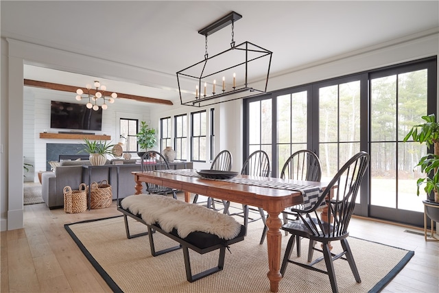 dining area with a notable chandelier and light hardwood / wood-style floors