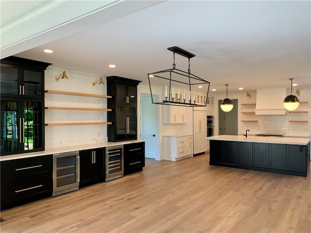 bar with decorative backsplash, light wood-type flooring, and beverage cooler