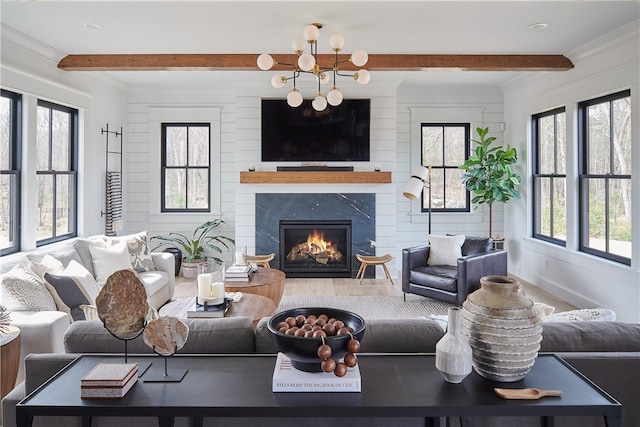 living room with plenty of natural light, a fireplace, and wood-type flooring