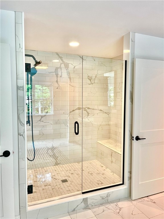 bathroom featuring tile patterned floors and a shower with door