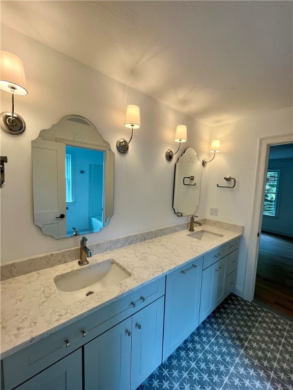 bathroom with dual vanity and tile patterned floors