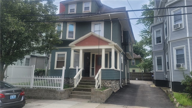 view of front facade with a porch and cooling unit