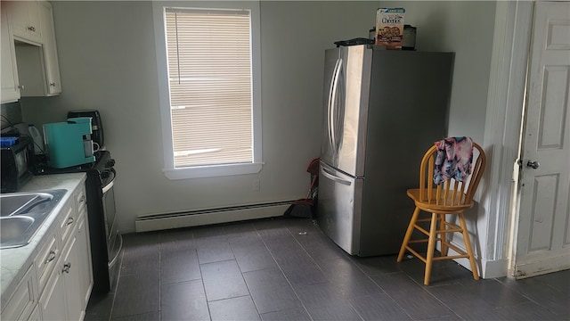 kitchen featuring dark wood-type flooring, stainless steel fridge, white cabinetry, and a baseboard radiator