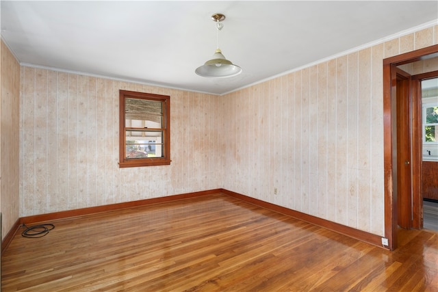 unfurnished room featuring crown molding and hardwood / wood-style flooring