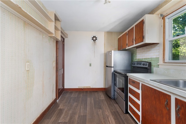 kitchen with dark hardwood / wood-style floors, stainless steel appliances, and backsplash