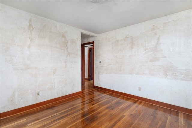 spare room featuring wood-type flooring