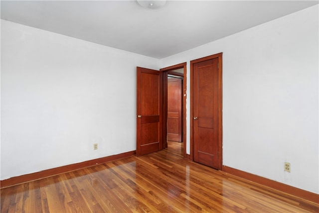 unfurnished bedroom with hardwood / wood-style floors