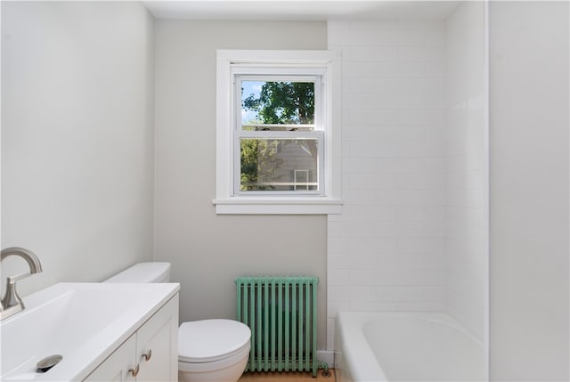 bathroom with vanity, radiator, and toilet