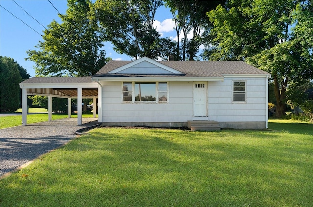 view of front of home with a front lawn and a carport