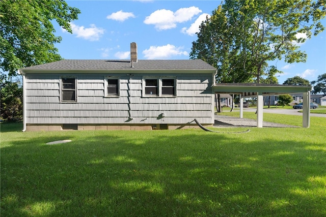 exterior space featuring a carport and a yard