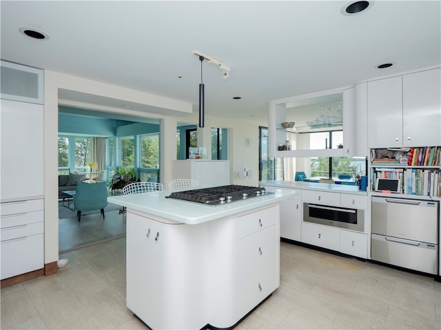 150 Southern Way, Charlestown, RI 02813 - kitchen featuring stainless steel appliances, light countertops, white cabinetry, a center island, and light flooring
