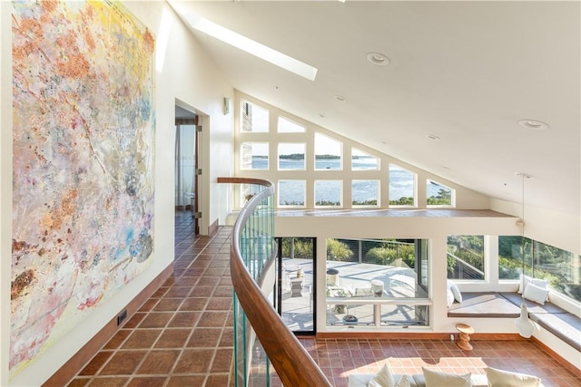 150 Southern Way, Charlestown, RI 02813 - hall with a skylight, high vaulted ceiling, recessed lighting, a water view, and baseboards