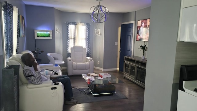 living room featuring dark hardwood / wood-style flooring and a chandelier