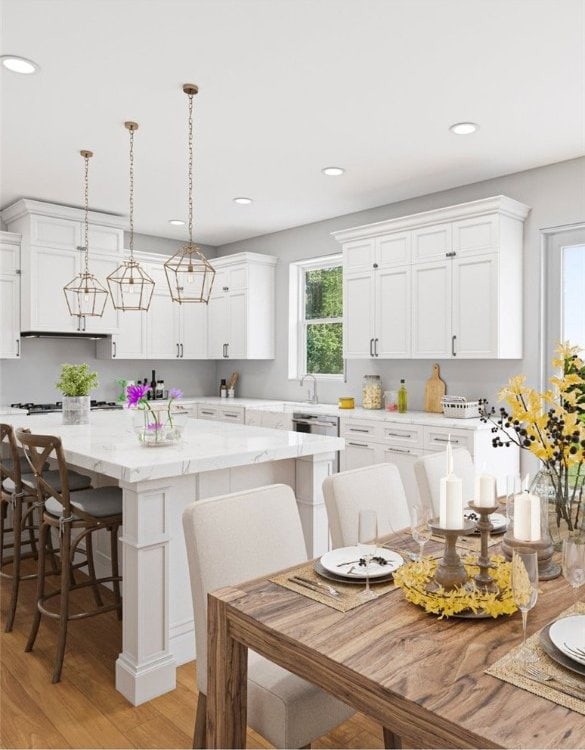 kitchen featuring a breakfast bar area, light stone counters, white cabinetry, light hardwood / wood-style flooring, and decorative light fixtures