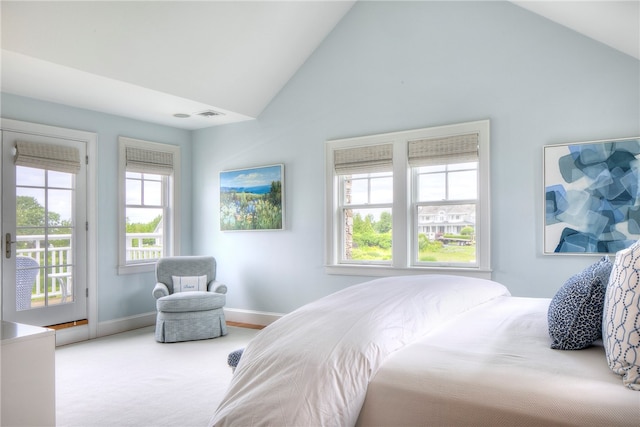 bedroom with carpet flooring, access to outside, and high vaulted ceiling