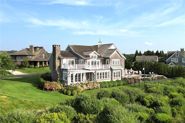 rear view of property with a lawn