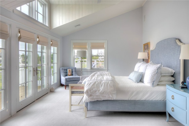 carpeted bedroom featuring multiple windows, high vaulted ceiling, and access to outside