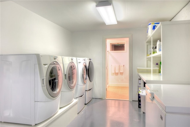 clothes washing area with light tile patterned floors and washing machine and clothes dryer