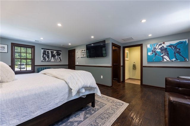 bedroom featuring hardwood / wood-style floors and ensuite bath