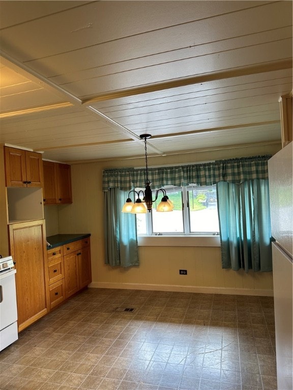 kitchen with tile patterned flooring, decorative light fixtures, and gas range gas stove