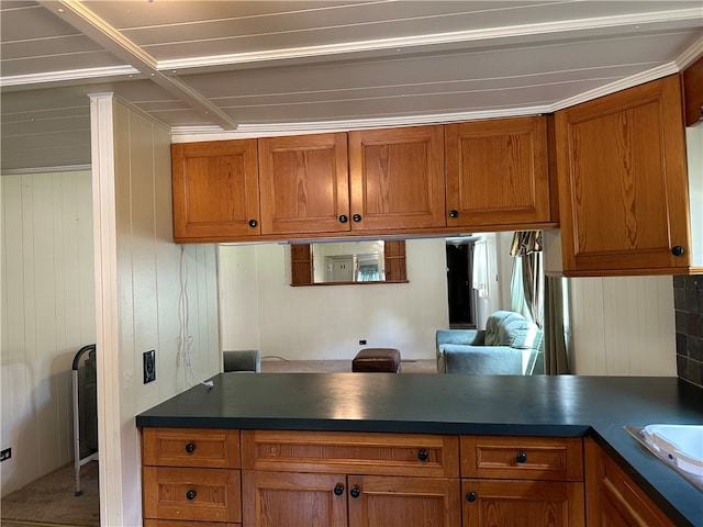 kitchen featuring sink, kitchen peninsula, and carpet flooring