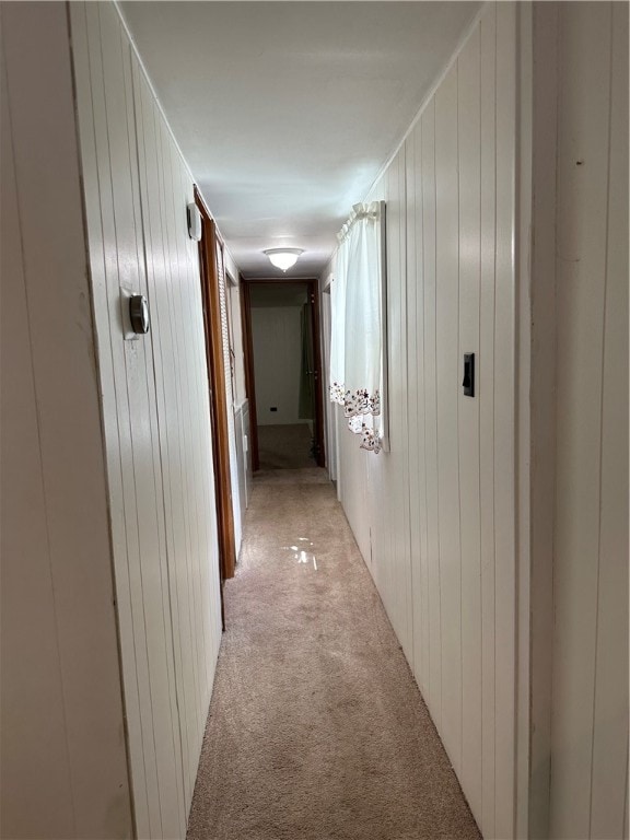 hallway with light colored carpet