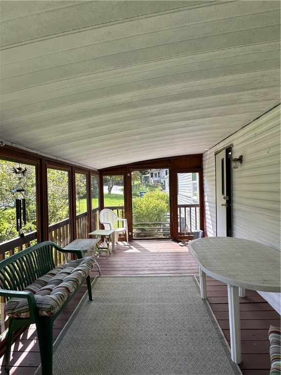 unfurnished sunroom featuring lofted ceiling