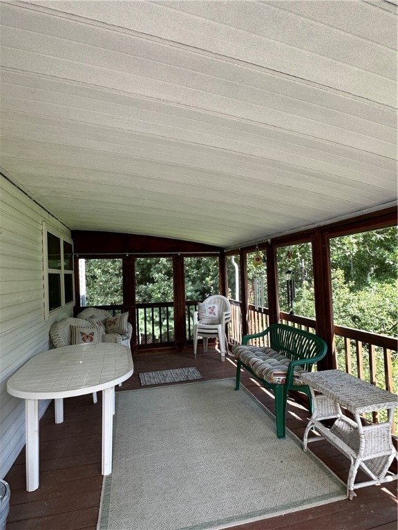 sunroom featuring vaulted ceiling