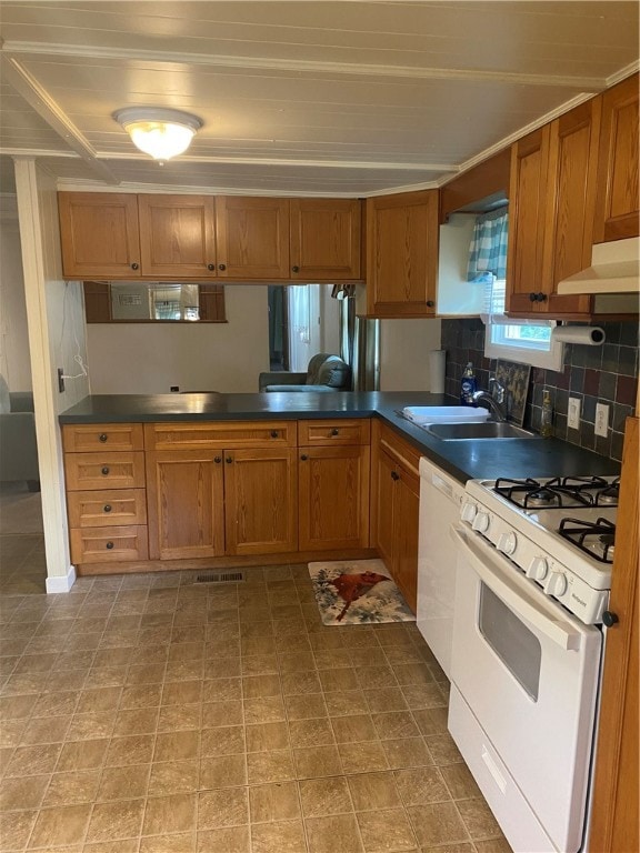 kitchen featuring backsplash, premium range hood, light tile patterned floors, kitchen peninsula, and white appliances