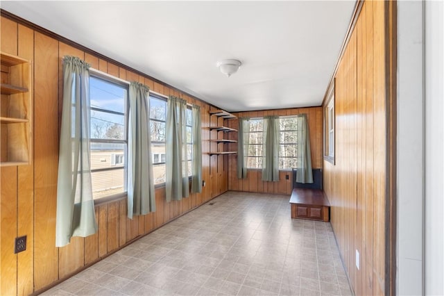 interior space with light floors and wooden walls