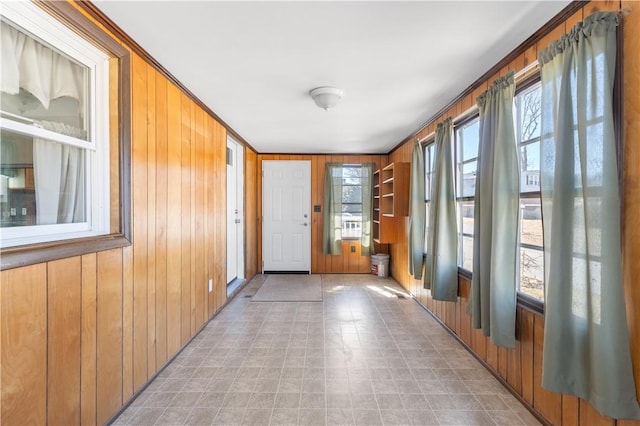 doorway featuring wooden walls