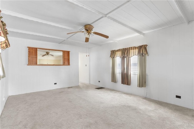 unfurnished room featuring carpet floors, visible vents, and a ceiling fan