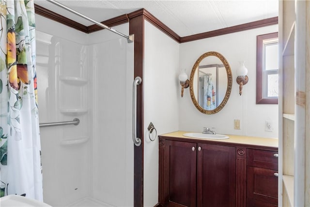 bathroom with ornamental molding, a stall shower, and vanity