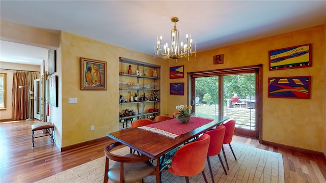 dining room with a notable chandelier and wood-type flooring